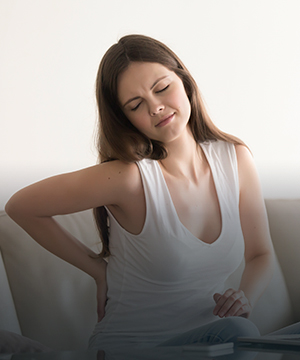 Woman with persistent lower back pain considering conservative care