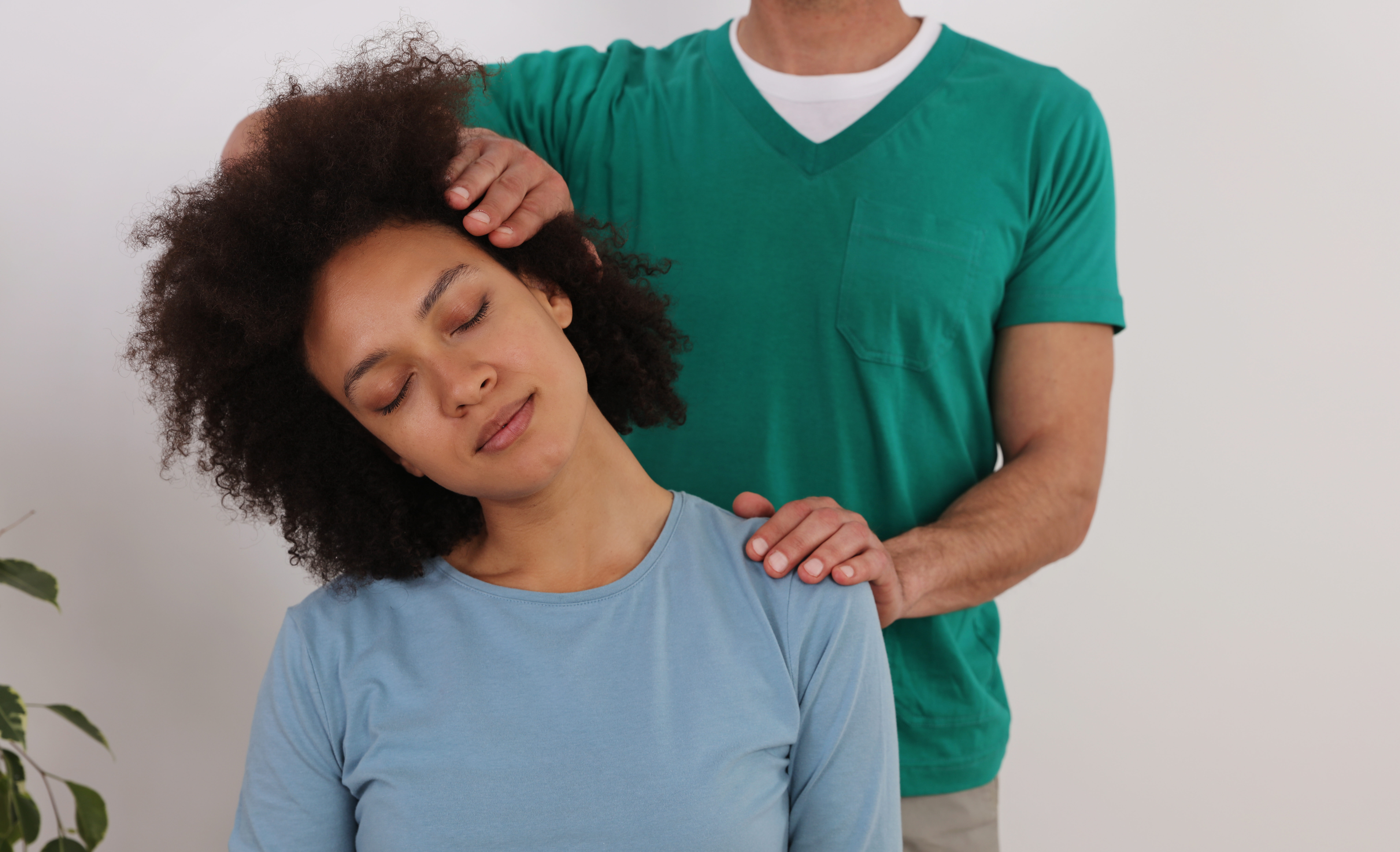 Patient receiving a neck evaluation after previous treatment