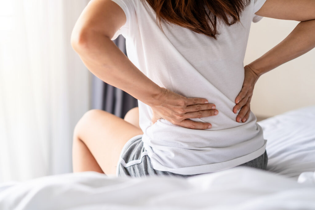 Person with lower back pain from a suspected bulging or herniated disc